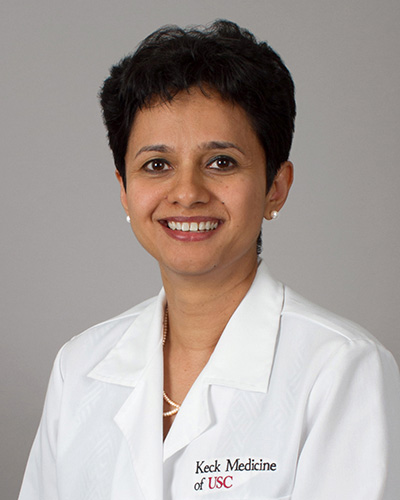 Headshot of Manju Aron